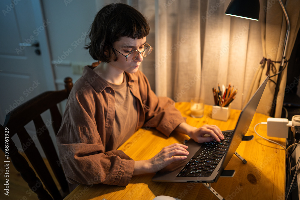Work Intensely Tense young woman work intensely on laptop deep into late night hours ...