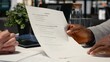 © DC Studio - Close up of black man reads monthly perks and salary options, meeting with a recruiter to discuss the benefits package for health insurance and wellness programs within contract deal.