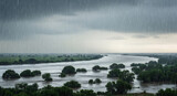 Monsoon season landscape of flooded river and trees under heavy rain. Ideal for climate change awareness, environment conservation, weather forecast, and disaster relief campaigns.