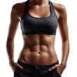 © vasyl pshyk - Fitness model showcases toned abdomen in workout attire during a studio photoshoot
