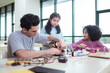 © Wosunan - A teacher guiding students in a robotics project during a STEM class in the library
