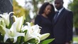 © Hyejin Kang - Couple near granite tombstone with white lilies at cemetery outdoors. Funeral ceremony concept.