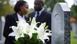 © Hyejin Kang - Couple near granite tombstone with white lilies at cemetery outdoors. Funeral ceremony concept.