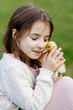 © Halfpoint - Young girl in garden playing with baby duckling.