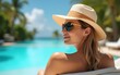 © zhao - Relaxing by the pool with a sunhat and sunglasses on a sunny day in a tropical location. High quality