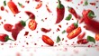 © Gendar SINURO - Vibrant red chili peppers and sliced pieces explode against a bright white background