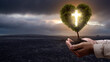 © Leo Lintang - Human hand holding light of the Christian cross on the heart tree with barren field and dark dramatic sky background. Concept of Christianity, religious, faith, Jesus, or belief