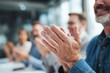 © grey - Businessman clapping during a meeting, showing encouragement and support for teamwork.