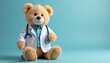 © Vadym - Teddy bear wears doctor coat. Plush toy holds stethoscope on light blue background. Doctor bear cute, furry. Concept for pediatric healthcare, medical professions, kids health themes. Animal