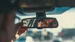 © Hot - wide shot of driver adjusting rearview mirror, focus on mirror reflection of their eyes, concept of awareness and safety