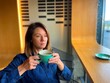 © Vlad - Close up of Caucasian attractive woman holding cup of coffee and looking away while sitting in coffee house with thoughtful face. Leisure concept. Female drinking coffee in cafeteria