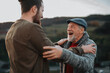 © Halfpoint - Grandson surprising grandfather, greeting each other in the middle of autumn park.