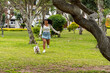 © Guillermo Spelucin - Young woman running with happy dog in park