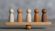 © crazyass - Balancing wooden figurines on seesaw business risk management insights in a creative workspace