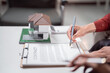 © Tj - Person is signing a real estate contract with a pen, preparing to buy a new home, symbolizing property investment, mortgage, and housing agreement concepts