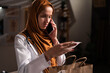 © Andrii Lysenko - Young Muslim woman doctor unpack takeaway food read cash bill receipt calling on smartphone working on night shift in hospital. Delivery service from shop or restaurant
