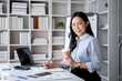 © Katcha - Accounting business concept, Accountant woman drinking coffee and writing information in notebook while