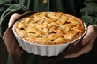 © New Africa - Woman with baking dish of delicious homemade apple pie against dark background, closeup