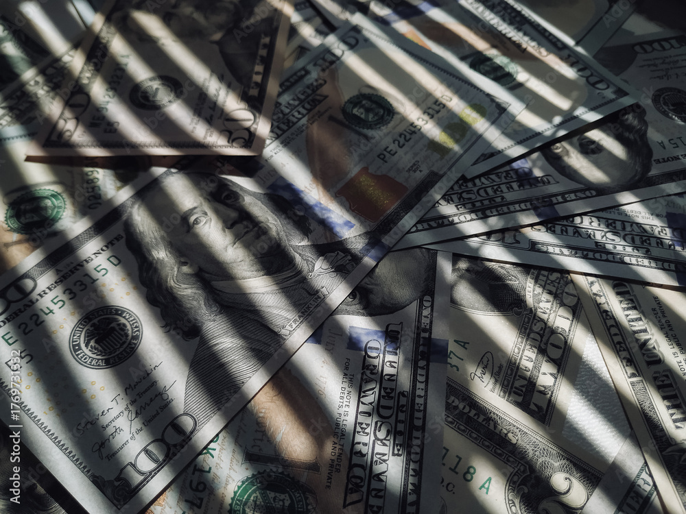 The horizontal shadow of the blinds resembles the grid on dollar bills ...