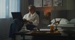 © Framestock - Mature Man in White Robe Works on Laptop in Cozy Hotel Room, With Breakfast and Coffee on Table in Peaceful Morning Atmosphere. Concept Remote Work, Freedom, and Modern Lifestyle of Travelers.