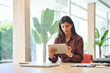 © Stock 4 You - Focused latin hispanic young woman using pad computer for business analysing. Busy executive CEO businesswoman professional holding digital tablet pc device working in office workplace. Copy space