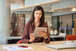 © Stock 4 You - Successful smiling latin hispanic young woman using pad computer for business app. Busy executive CEO businesswoman professional holding digital tablet pc device for work in modern office workplace.