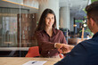 © Stock 4 You - Young indian or european bank worker woman shaking hand with client hr manager welcome recruit employee. Middle eastern arab businesswoman showing greeting after signing contract with business partner