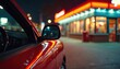 © Pete - Red car at a colorful drive-thru fast food restaurant at night. Bright neon lights illuminate the scene. City street with glowing signage creating an urban atmosphere.