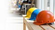 © Running opossum - three colorful construction helmets on a wooden table in a sunlit modern office setting