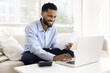 © fizkes - Happy African guy feels satisfied while planning budget