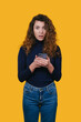 © Strelciuc - vibrant studio photograph of delighted woman holding mobile device with cheerful expression