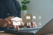 © MUNTHITA - Online learning concept with person using laptop and digital education icons, e-learning platform, virtual classroom and online training for modern education technology and digital transformation.