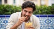 © Bayu Tri Nugroho - Young man enjoying street food with fries in a park while taking a break in the city Delicious snack and junk food Enjoying the day carefree moments in the urban landscape