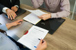 © AntonioDiaz - Closeup of couple signing divorce agreement with legal counsel