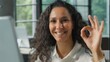 © Yuliia - Hispanic business woman with computer showing ok sign smiling in office ethnic businesswoman female professional manager working using online internet software okay sign approval gesture good app