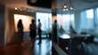 © ryker - Modern office interior with blurred team meeting and glass partition creating reflective depth and warm evening light, conveying collaborative atmosphere and professional focus