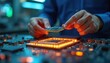 © miss irine - Technician holds processor above circuit board. Man works in tech laboratory with motherboard, microchips. Engineer checks hardware, tests computer electronics for performance, quality. Server