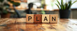 © Natalia Klenova - Wooden Blocks Spelling Plan on a Table, Office Banner