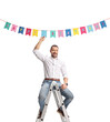 © Ljupco Smokovski - Man on a ladder putting birthday decoration flags