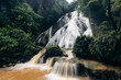 © Connect Images - Lush green waterfall cascading over rocks surrounded by tropical forest. Ambon, Maluku, Indonesia