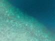 © Connect Images - Aerial view of a deep blue ocean meeting a light sandy seabed along a diagonal line. Pantai Ngurbloat or Ngurbloat Beach in Kei Kecil, Southeast Maluku, Indonesia