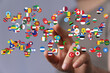 © vegefox.com - A person's hand interacting with a collection of flags from various countries representing the concept of global connections, international rela
