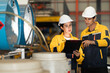 © Montri - Female and male engineers in safety uniforms discussing fluid system inspection at factory. Industrial teamwork, engineering process, and workplace safety in manufacturing. engineer, two worker.
