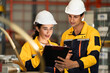 © Montri - Female and male engineers in safety uniforms discussing fluid system inspection at factory. Industrial teamwork, engineering process, and workplace safety in manufacturing. engineer, two worker.