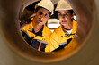 © Montri - Two engineers inspecting the inner surface of a large metal pipe. Wearing safety uniforms and helmets. Concept of industrial inspection, quality control, and manufacturing process.