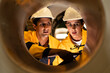 © Montri - Two engineers inspecting the inner surface of a large metal pipe. Wearing safety uniforms and helmets. Concept of industrial inspection, quality control, and manufacturing process.