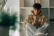 © carballo - teenager at home with cell phone sitting on the floor