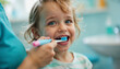 © Arra Vais - Child Smiling While being Brushed Teeth in Bright Bathroom for Parenting Blogs, Dental Health Websites, Oral Hygiene Campaigns, and Educational Content