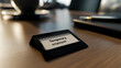 © photo for everything - A nameplate labeled 'Temporary employee' sits on a desk next to a pen and a cup of coffee. The nameplate is black with a white label, highlighting contract roles in the modern workplace.