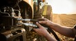 © velikiyzayats - Agricultural Machinery Maintenance: Close-Up of Hands Connecting Hydraulic Hoses on a Tractor in Golden Hour Light